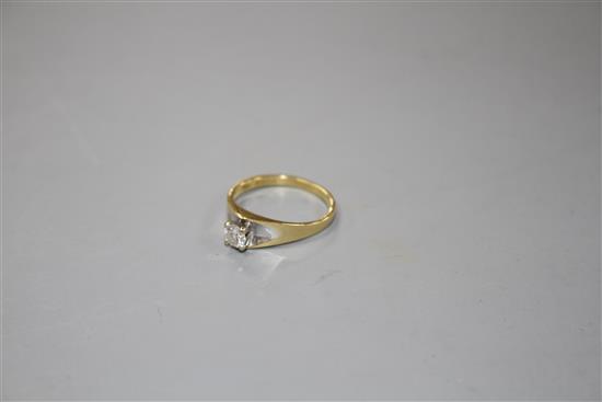 A modern 18ct gold and solitaire diamond ring,